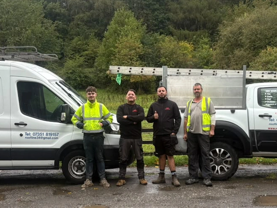 Dean Price and the MCR Rooflines team with the company van and pickup